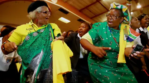 AFP Supporters of the ruling South African political party the African National Congress (ANC) dance and sing before the arrival of the South African president and president of the African National Congress (ANC) during a campaign event at the Inter-fellowship Church in Wentworth township, outside of Durban, on April 9, 2014, ahead of elections on May 7