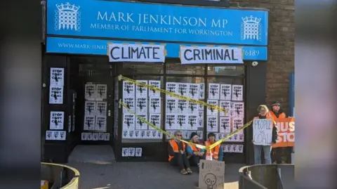 Just Stop Oil Just Stop Oil protesters sitting outside Mark Jenkinson MP's office 