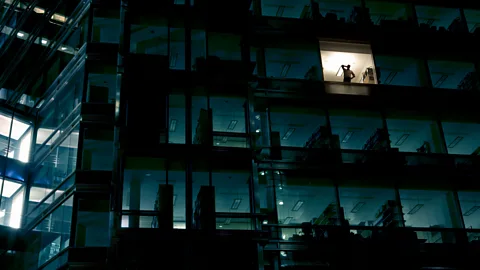 Getty Images person working alone in skyscraper