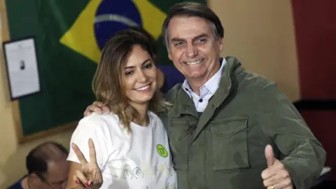 EPA Mr Bolsonaro, right, and his wife Michelle voting in Rio de Janeiro