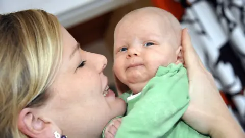 Getty Images Mother holds baby in Helsinki (file pic)