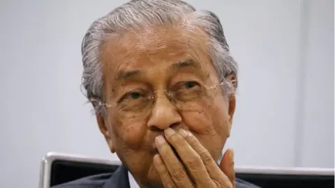 Reuters Malaysia's former Prime Minister Mahathir Mohamad reacts during a news conference in Kuala Lumpur, Malaysia December 14, 2020
