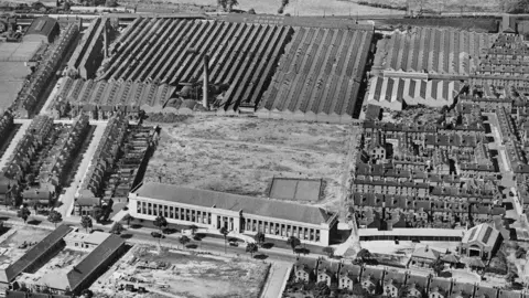 Historic England Black and white aerial shot of Howitt Building with Raleigh factories behind